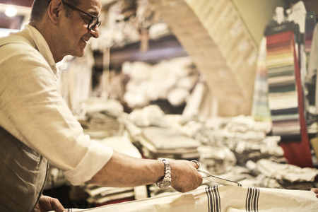 Artisan at work with fabricsの写真素材
