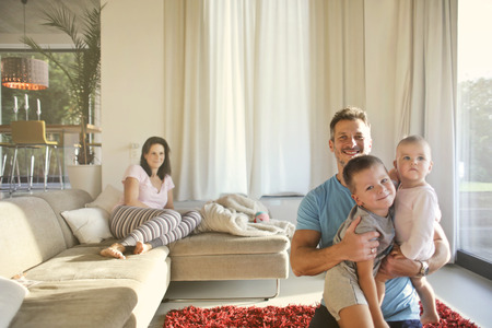 Happy family in a living roomの写真素材