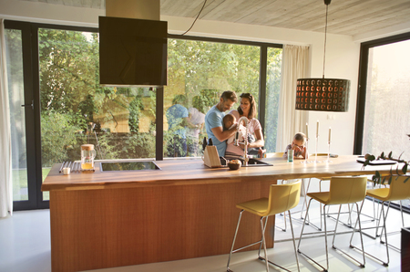 Happy family in a modern kitchenの写真素材