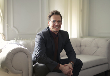 Smiling businessman sitting on a sofaの写真素材