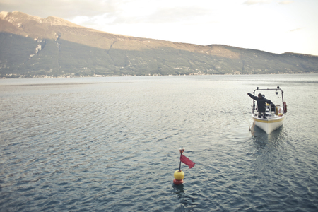 A landscape with a lake and a boat