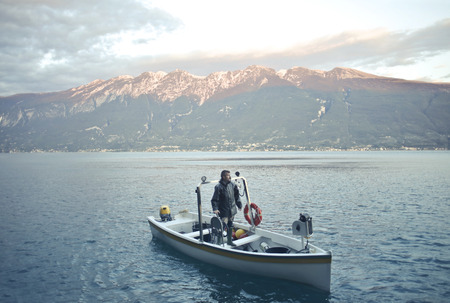 A landscape with a lake and a boatの写真素材