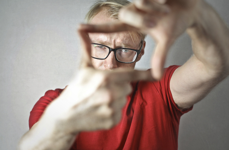 Portrait of a man making a symbol with his handsの写真素材