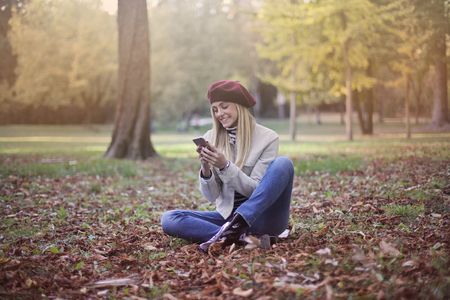 Girl with a smartphone in a natural contextの写真素材