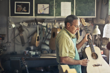 Artisan at work on a guitarの写真素材
