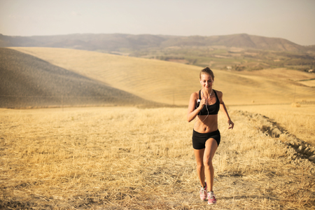 Sporty girl running in the countrysideの写真素材