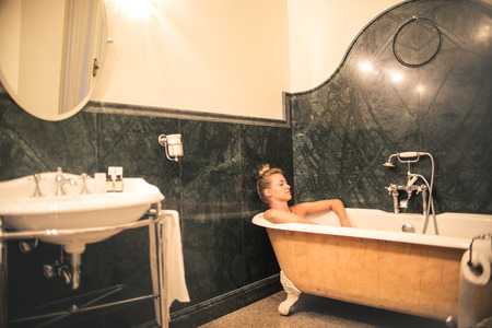 Girl who takes a bath in a tubの写真素材