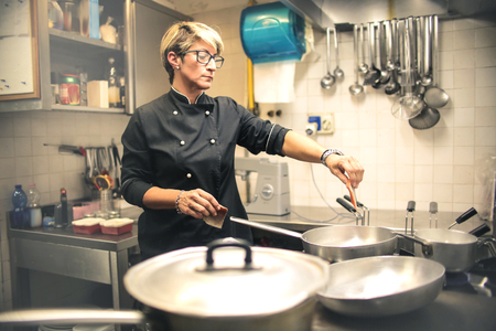 Chef cooking in a restaurant kitchenの写真素材