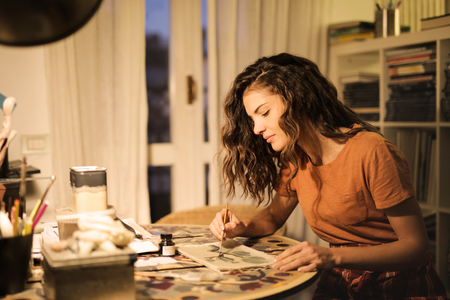 Creative girl painting at homeの写真素材