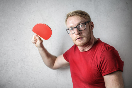 Guy with a red t-shirt playing table tennisの写真素材