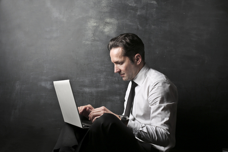 Portrait of a businessman with a laptopの写真素材