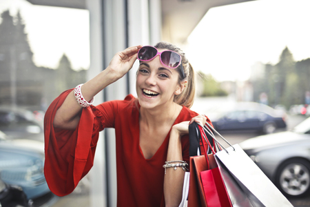 Happy girl with shopping bags outdoorの写真素材
