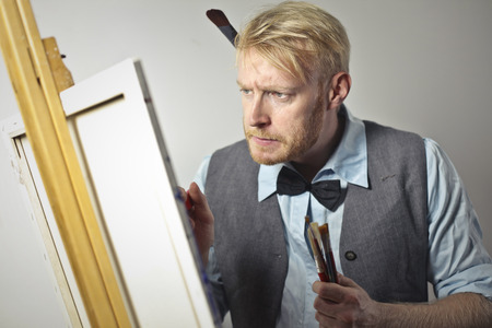 Painter at work on a canvasの写真素材