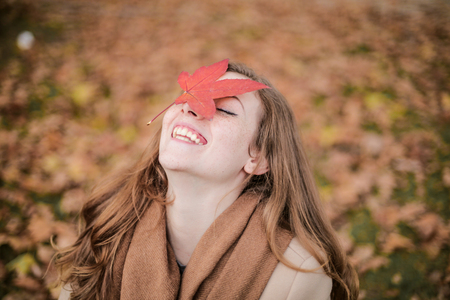 Happy girl in a natural context in autumnの写真素材