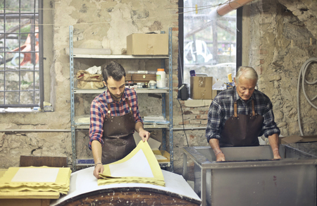 Two artisans at work in a laboratoryの写真素材