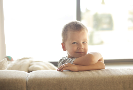 Portrait of a child on a sofaの写真素材