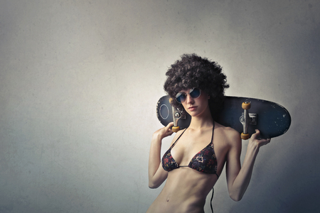 Portrait of a skater girl in bikiniの写真素材