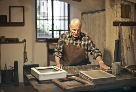 Aged artisan at work in a laboratoryの写真素材