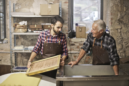 Two artisans at work in a laboratoryの写真素材