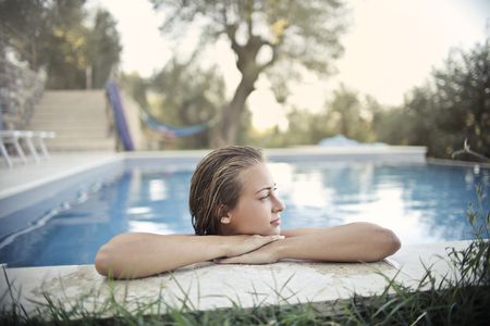 Girl relaxing in a swimming poolの写真素材