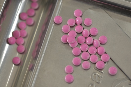 Pink medicine on tray.
