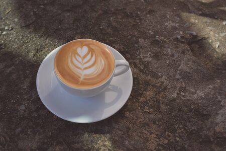 A cup of latte coffee with textures background.の素材
