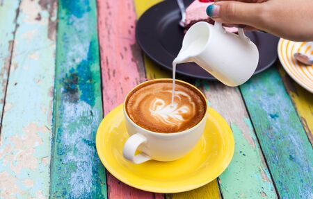 Pour milk to Coffee cup,hot drink, tea milk,milk in jug
