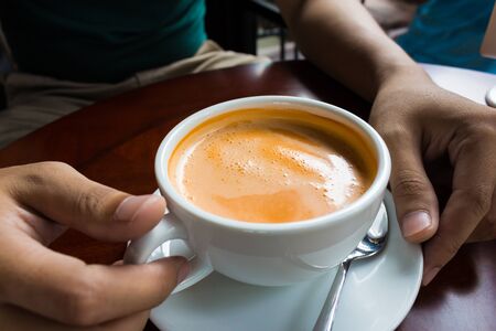 hand holding a cup of coffee hot drink design concept