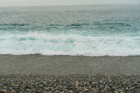 sea wave on the pebble beach, closeup of photoの写真素材