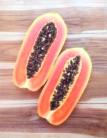slices of sweet papaya on wooden backgroundの写真素材