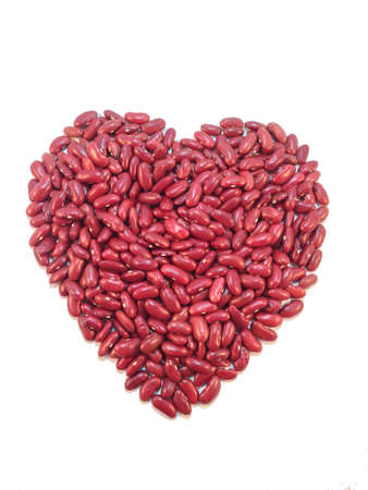 Heart shaped red bean on white backgroundの写真素材