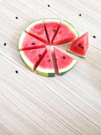 slices of watermelon look like cake on Wooden floorの写真素材