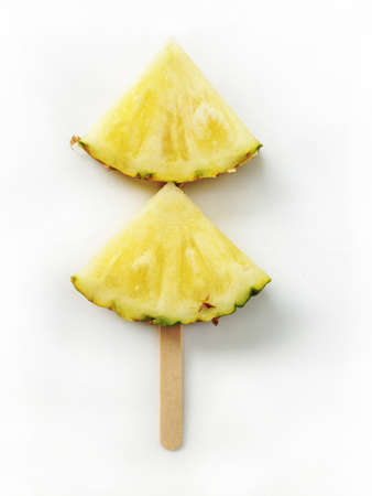 Pineapple slices isolated with sticks on white background