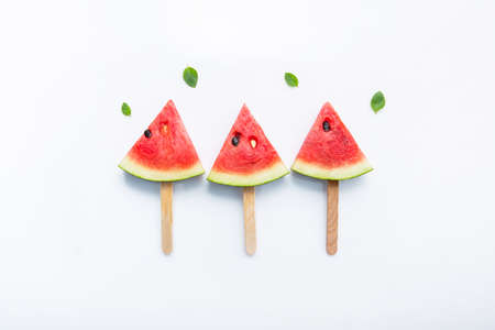 Watermelon slice popsicles on white backgroundの写真素材