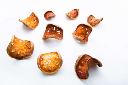 Fruit herbs, Bael dried on white wooden table.