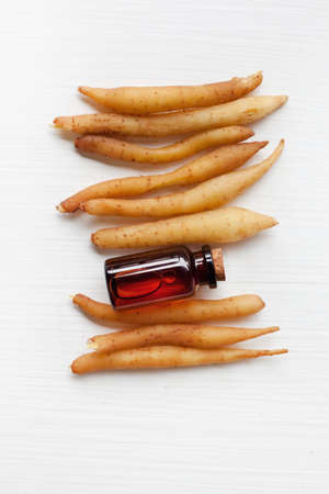 Lesser Galangal Essential Oil on White Background.