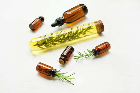 Glass bottle of essential oil  with rosemary. Top viewの写真素材