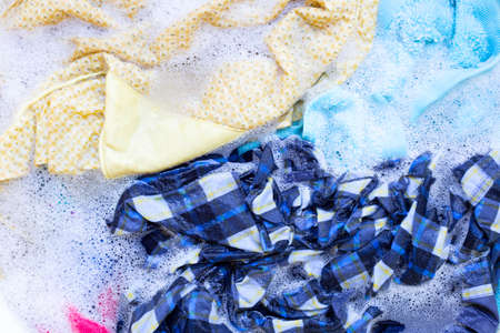 Washing clothes, colorful clothes soaked.の写真素材