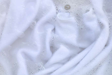 Washing clothes, white clothes soaked.