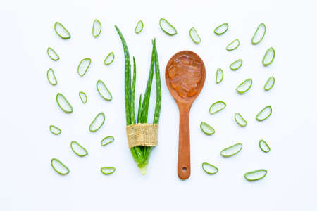 Aloe vera and slices with aloe vera gel on wooden spoon isolated on white background.の写真素材