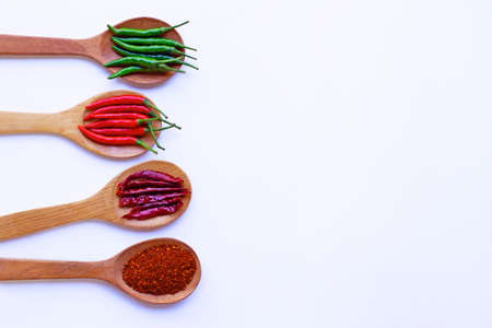 Hot chili pepper on wooden spoon, White background. Copy spaceの写真素材