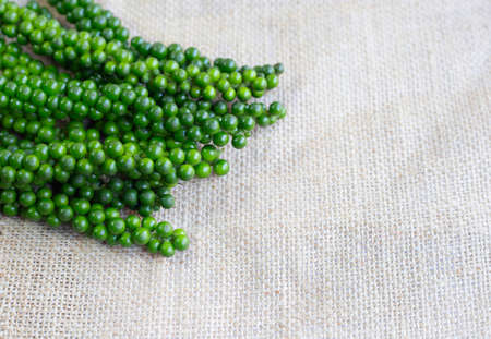 fresh green peppercorns  on sackcloth backgroundの写真素材