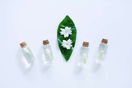 Essential oil with jasmine  flower on white background.