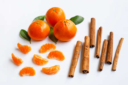 Mandarin orange with cinnamon stick on white Backgroundの写真素材