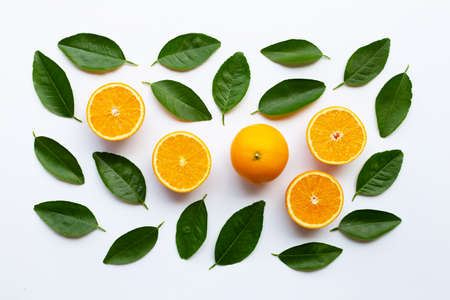 Oranges and green leaves on white background.の写真素材