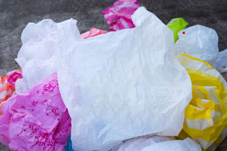 Colorful plastic bags on cement floor backgroundの写真素材