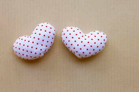 Valentine's hearts on brown cardboard paper background.