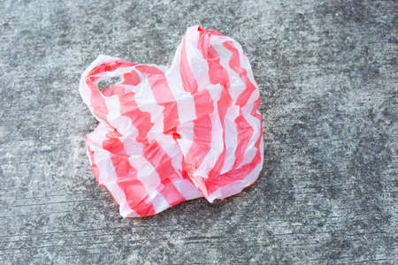 Plastic bag waste on cement floor backgroundの写真素材