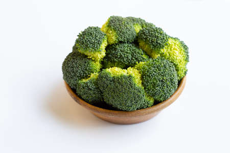 Wooden bowl of broccoli on white background. Healthy green organic vegetableの写真素材