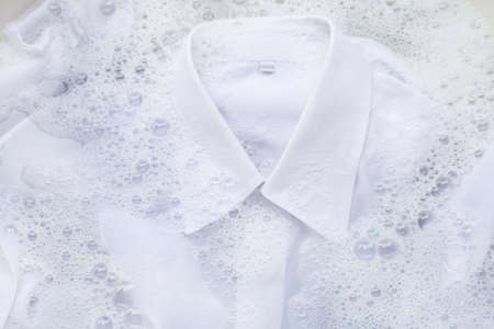 Soak a cloth before washing, white shirtの写真素材